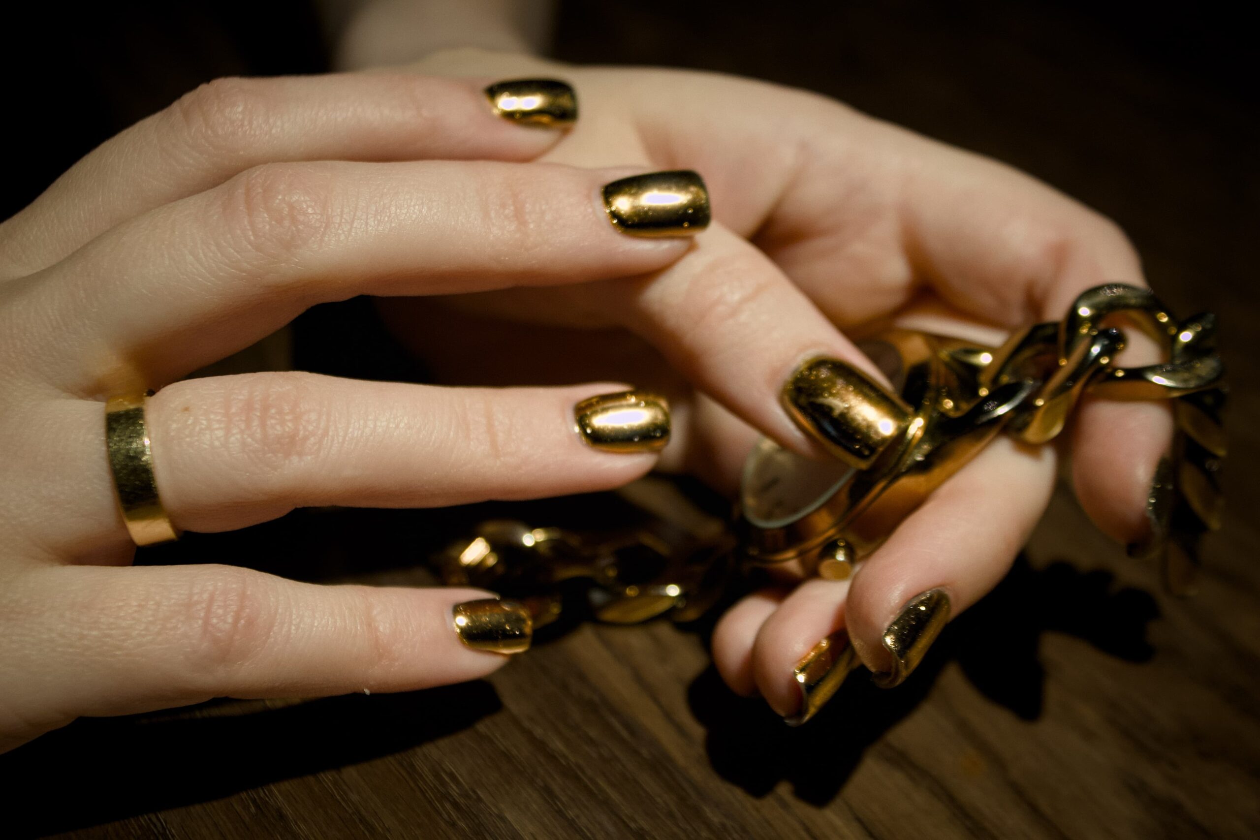 woman-is-holding-gold-instrument-with-gold-glitter-it-min-min